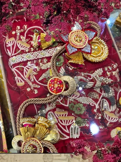 A framed collage showing the red embroidered outfit, highlighting the intricate details of both the garment and the decorative packing.