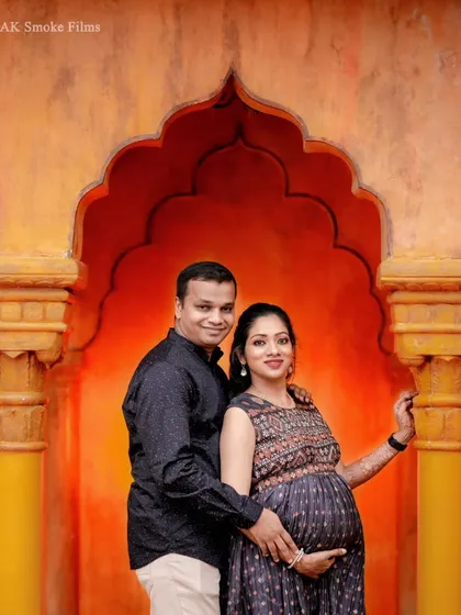 We use architectural elements to create stunning portraits. This couple is framed by a traditional Indian-style archway with warm, glowing light, blending modern attire with classic design.