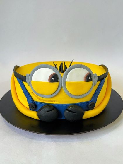 You are one in a minion! This playful Minion cake is carved to shape and covered in fondant to capture the character's iconic look. It's a fun design that's sure to make everyone smile.