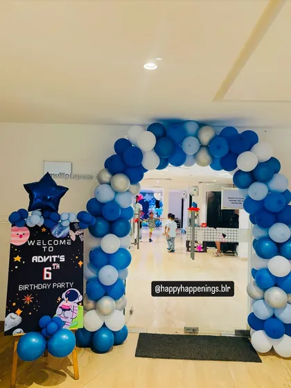 The entrance to Advit's space party, designed to wow guests from the moment they arrived. A blue, white, and silver balloon arch framed the doorway, with a custom welcome sign setting the stage for the adventure inside.