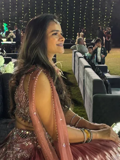 A candid side profile, capturing a happy moment during the wedding festivities.