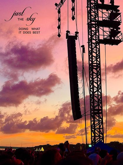 The sky doing what it does best. A dramatic sunset with purple and orange clouds seen from a music festival.