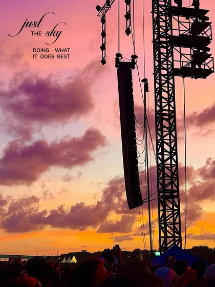 The sky doing what it does best. A dramatic sunset with purple and orange clouds seen from a music festival.