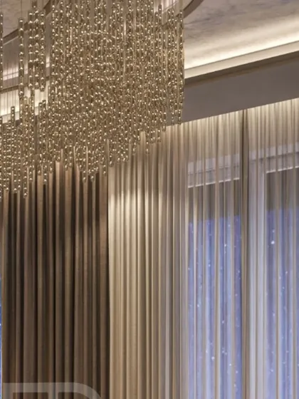 A detail of the layered curtains against the night sky, with the glow of the chandelier. This highlights my focus on how a space feels at all times of the day.