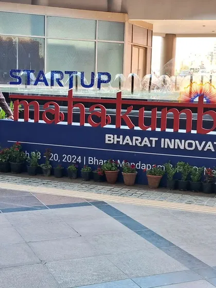 Standing by the Startup Mahakumbh sign at Bharat Mandapam, New Delhi. Participating in this event was a significant step in our journey to scale our impact.