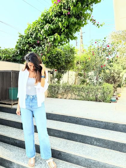 Looking down, this shot shows the relaxed fit of the wide-leg jeans, a comfortable and on-trend silhouette.