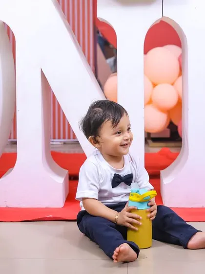 A candid moment of the birthday boy exploring his party. These natural shots capture his budding personality and curiosity.