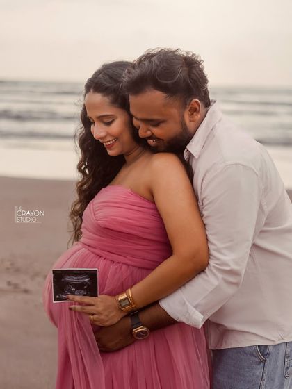 Sharing the first glimpse of their baby with a sonogram picture. This is such a special moment to capture during a maternity shoot, full of love and excitement.