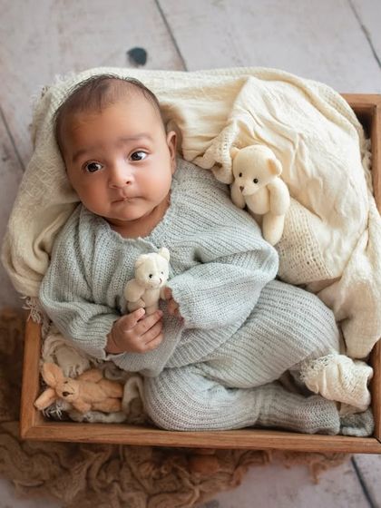 An individual portrait of the baby boy from the twin set, looking curious and wide-eyed. I always make sure to get solo shots of each twin.
