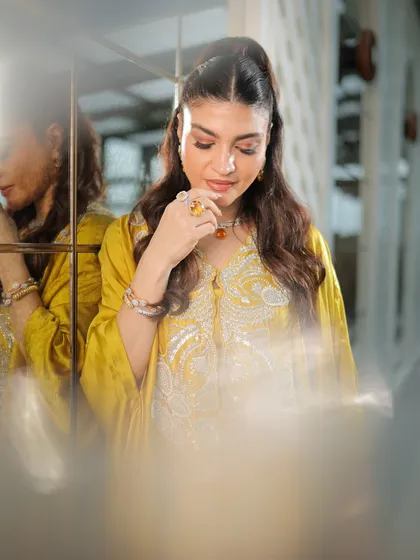 A dreamy, soft-focus shot. This image captures the effortless glamour and radiant finish of the makeup look.