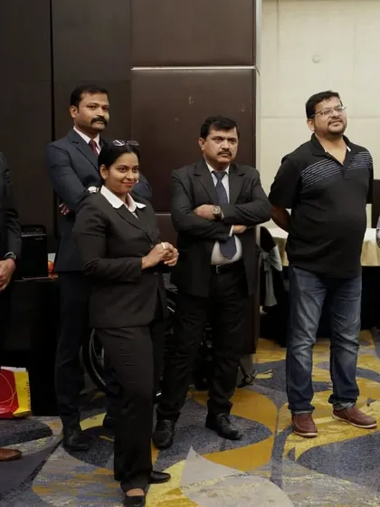 Our team members stand with guests during the charity lunch for the Spastic Society of Karnataka. These events are a collaborative effort filled with heart.