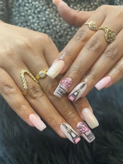 Take a trip to the city of love with our hand-painted Paris-themed nail art. This custom design features detailed illustrations of the Eiffel Tower and romantic roses on a soft pink and glitter base, showcasing our ability to bring any concept to life.