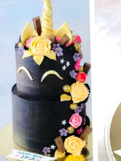 A slightly different angle of the chocolate unicorn cake, highlighting the golden horn and ears.