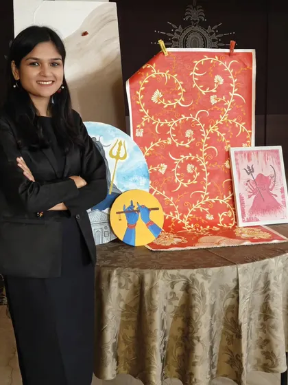 Just me, surrounded by my creations. This collection includes a mix of canvas paintings and painted fabric, showcasing different styles from spiritual motifs like Shiva and Krishna to abstract floral patterns.
