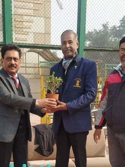 Being presented with a plant as a token of appreciation at the Inter-University Championship. It is an honor to be recognized for our contributions to the basketball community.