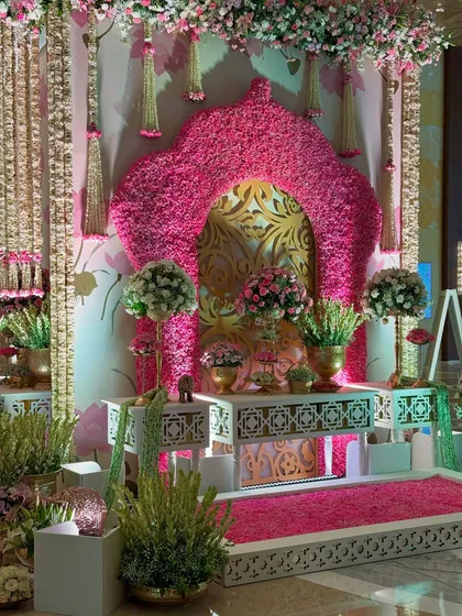 Another angle of the opulent floral corner, showcasing the hanging flower strings and the intricate white console tables that add to the traditional, luxurious feel.