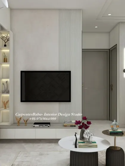 The TV unit in this 2BHK is simple and clean, with a floating console and a backlit display niche. The design prioritizes function without sacrificing style.