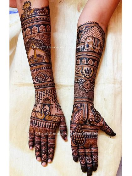 A full view of a bridal design with a diya, swans, and elephants, showing the complete story.