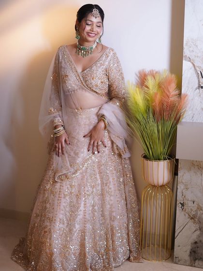 A full-length view of this bride's stunning pastel lehenga. My makeup and styling are designed to celebrate her natural beauty and create an unforgettable glow.