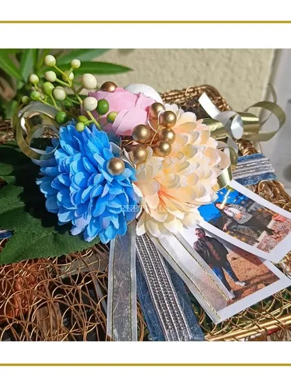 A beautiful floral arrangement with photo prints, part of a larger custom hamper, adding a personal and decorative touch.