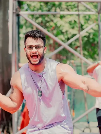 On the mic, hyping up the crowd at a huge Holi party. My job is to be an entertainer, and I bring my full energy to get thousands of people celebrating together.