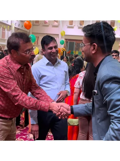 Shaking hands with a guest after a performance. Building rapport is just as important as the trick itself.