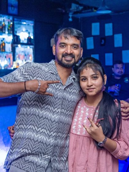 This couple is all about the rock and roll hand signs.