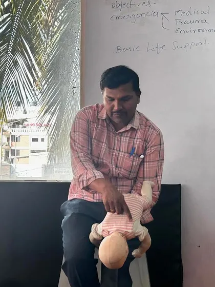 An instructor demonstrating how to provide first aid for a choking infant, an important part of our comprehensive safety training.