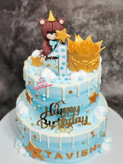 I loved creating this two-tier cake for a little one's first birthday. It features a cute, handcrafted teddy bear topper, a golden crown, and a gentle white chocolate drip over a dreamy blue frosting, making it perfect for a prince's celebration.