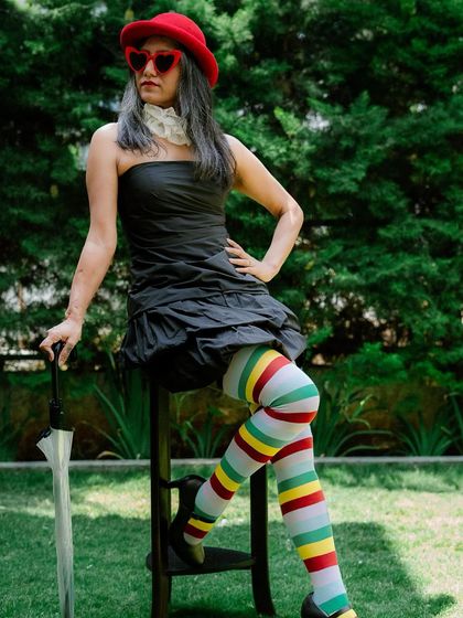 Posing with an umbrella as a prop, this look is a modern take on a classic storybook character.