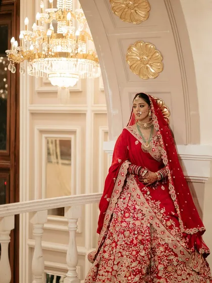 A regal pose from my beautiful bride Sona. Her makeup features a classic combination of defined eyes and a balanced complexion, perfectly complementing her stunning red and gold ensemble.