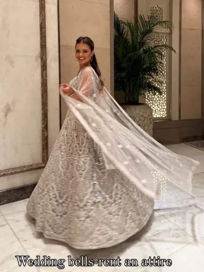 My gorgeous client dazzling in a heavy silver lehenga. She looks like a dream, twirling and shining at her event. This is the magic of renting luxury!