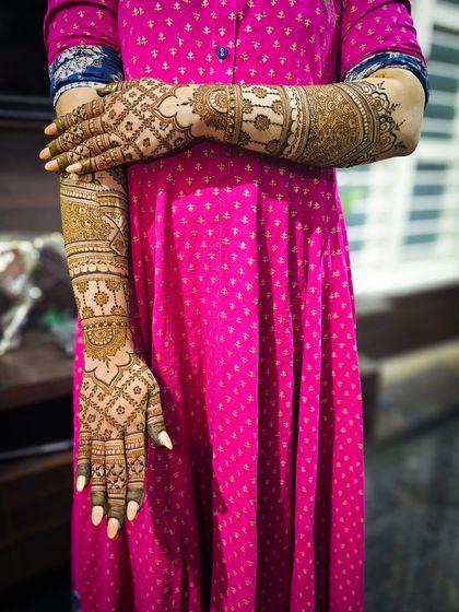 A creative pose showing the full design on both arms.