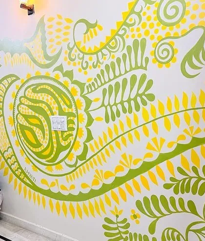 This is the 'Harmony' mural, a piece very close to my heart, celebrating the love of a joint family. The four little birds represent the children, protected and nurtured within their family's wonderland. My art often tells a personal story, and this one is all about togetherness.