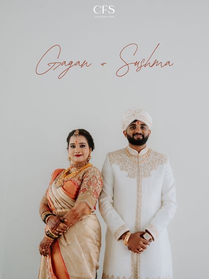 A clean, classic portrait of the couple in their beautiful South Indian wedding attire. The simplicity of the shot emphasizes their elegance and connection.