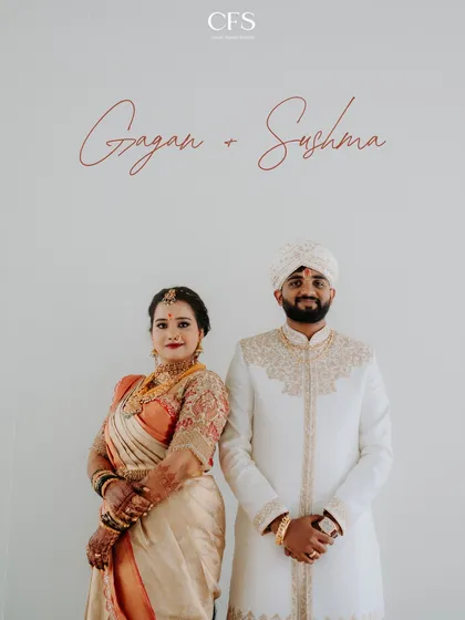 A clean, classic portrait of the couple in their beautiful South Indian wedding attire. The simplicity of the shot emphasizes their elegance and connection.