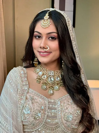 Subtle glamour for the bride who dreams in hues of love. This bride looks stunning in her pastel lehenga, with soft pink eyeshadow and a radiant smile.