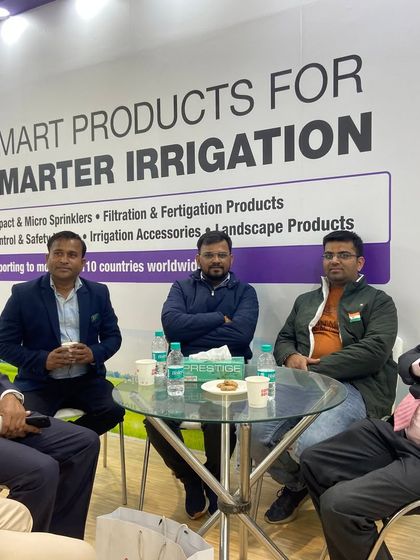 A candid shot of a meeting at our PlastIndia booth. We foster an environment of open conversation to build lasting business relationships.