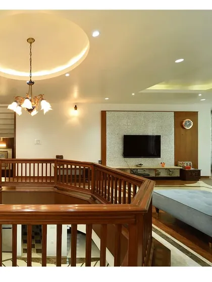 The double-height living space with a wooden railing, creating a visual connection between floors.