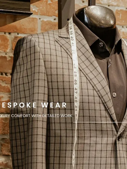 A checked suit on a mannequin, with the tailor's measuring tape draped over it. This showcases the intersection of classic patterns and personalized craftsmanship, with meticulous attention to detail.