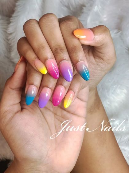 A vibrant and colorful sunset-inspired ombre, blending yellow, pink, purple, and blue.