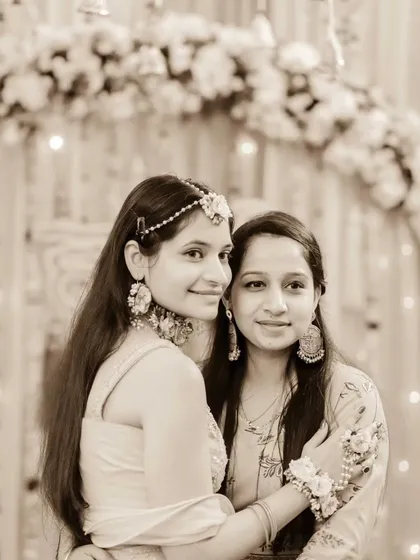 Sisters sharing a sweet moment at the Haldi ceremony. This photo captures their close bond and happiness during the pre-wedding celebrations.