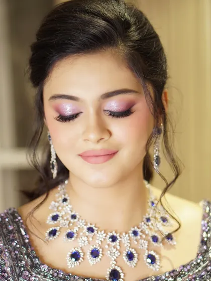 A closer look at the soft lilac shimmer on the eyes. Paired with a flawless complexion and a simple updo, this makeup is the epitome of modern, elegant glamour.