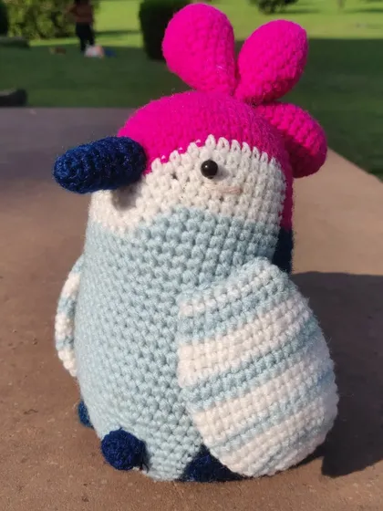 Meet Chikoo, the party bird. This colorful amigurumi is always ready for a good time. Her bright pink and blue feathers make her a fun and eye-catching toy.