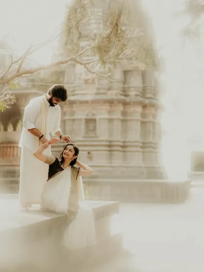 A dreamy and romantic pre-wedding portrait at a heritage temple. The soft, hazy light and the couple's gentle interaction create a timeless image that feels both peaceful and deeply personal.