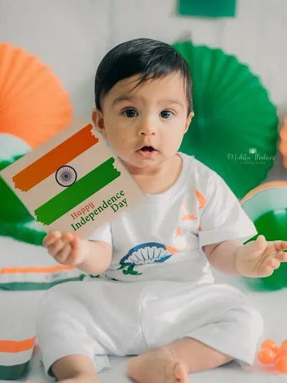 This little patriot is holding up a card to wish everyone a Happy Independence Day.