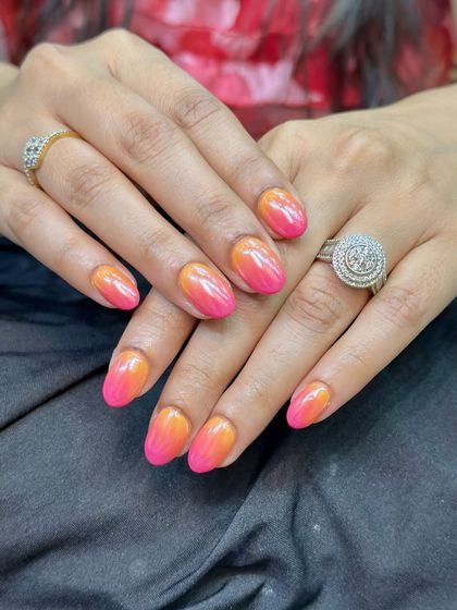 This look is achieved by blending colored gel polishes and finishing with a chrome top coat for that extra shine.