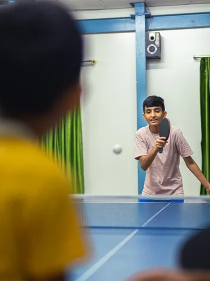 The rally continues. This over-the-shoulder shot puts you right in the middle of an intense point between two young, focused players.
