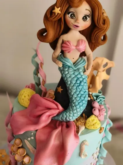 A close-up of the beautiful mermaid figurine from Abigail's birthday cake. I spent hours sculpting her flowing hair and hand-painting her face to give her a sweet, doll-like appearance.