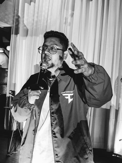 Explaining a bar to the audience. It's not just a performance, it's a conversation.